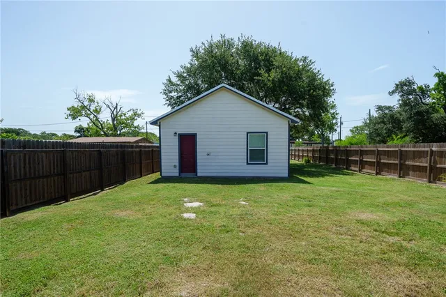 a view of a garden with a wooden fence