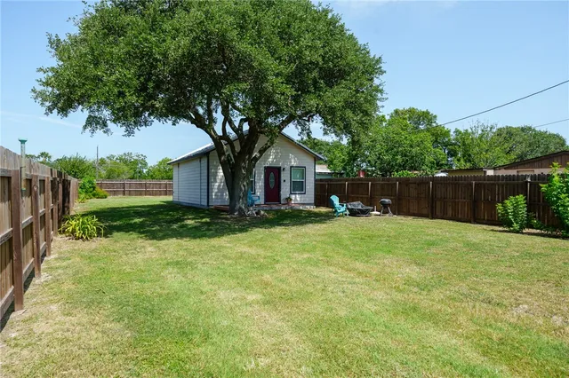 a front view of house with a garden