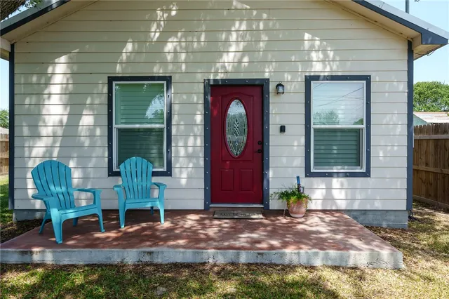 a front view of a house with outdoor seating
