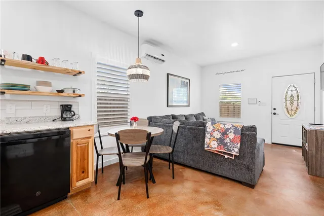 a living room with furniture a dining table and a fireplace