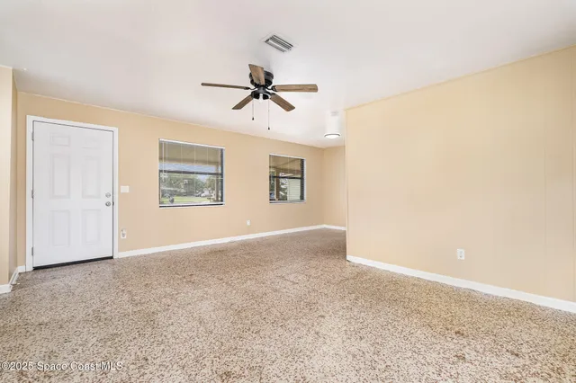 a view of a big room with carpet