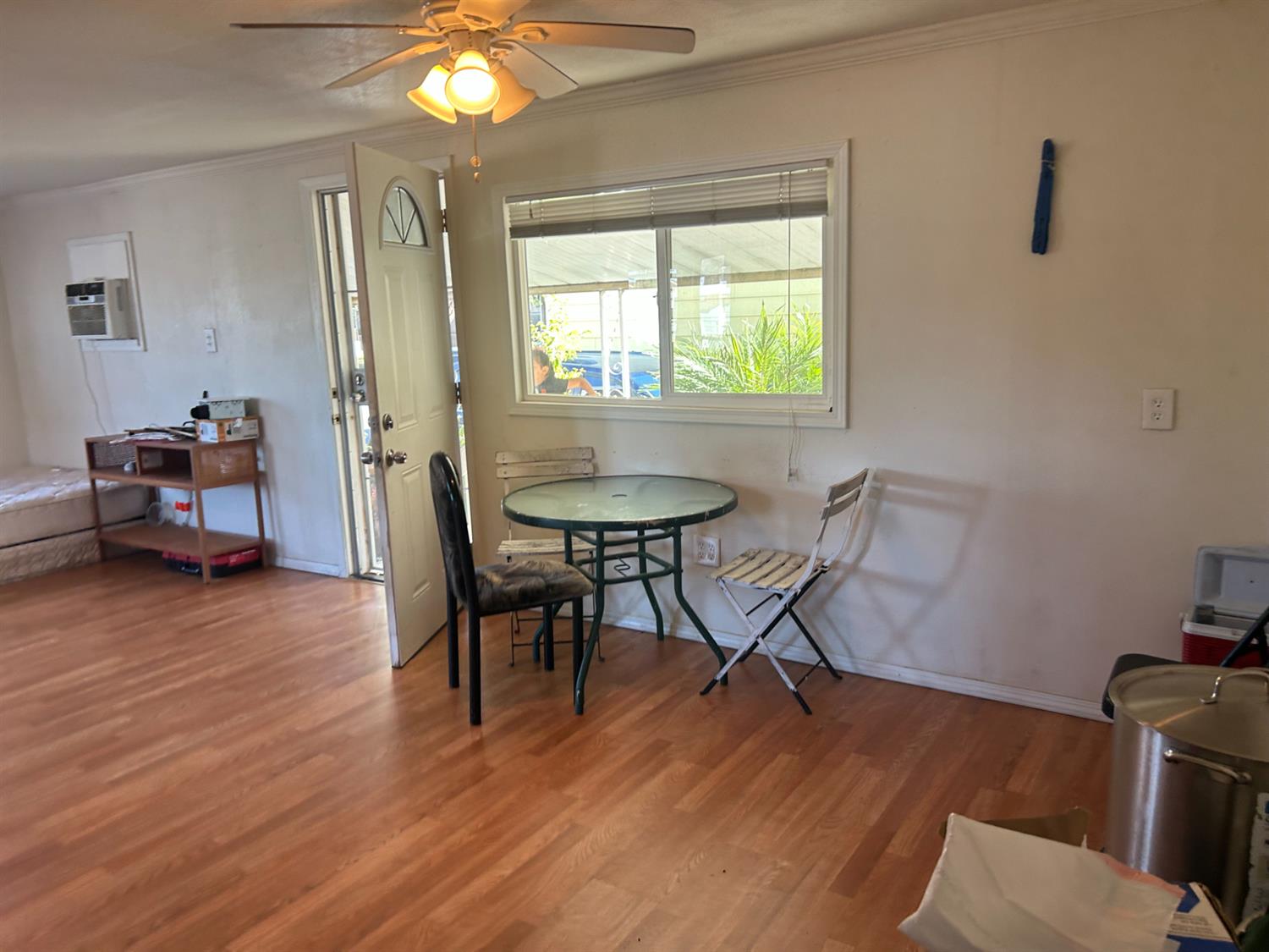 1781 Franklin Road, Unit 59 Yuba City, CA 95993 - Photo 4 of 17 a dining room with wooden floor a chandelier a glass table and chairs