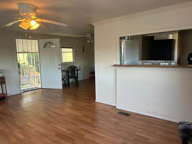 a view of a livingroom with furniture wooden floor and windows