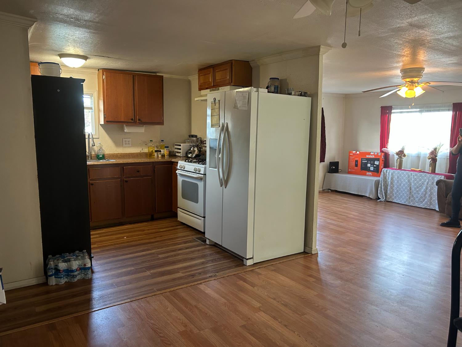 1781 Franklin Road, Unit 59 Yuba City, CA 95993 - Photo 8 of 17 a kitchen with stainless steel appliances a refrigerator a stove a sink dishwasher and a oven with wooden floor