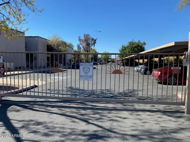 a view of a brick house with wooden fence