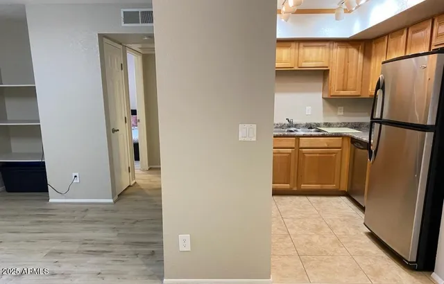 a kitchen with stainless steel appliances a refrigerator and a stove