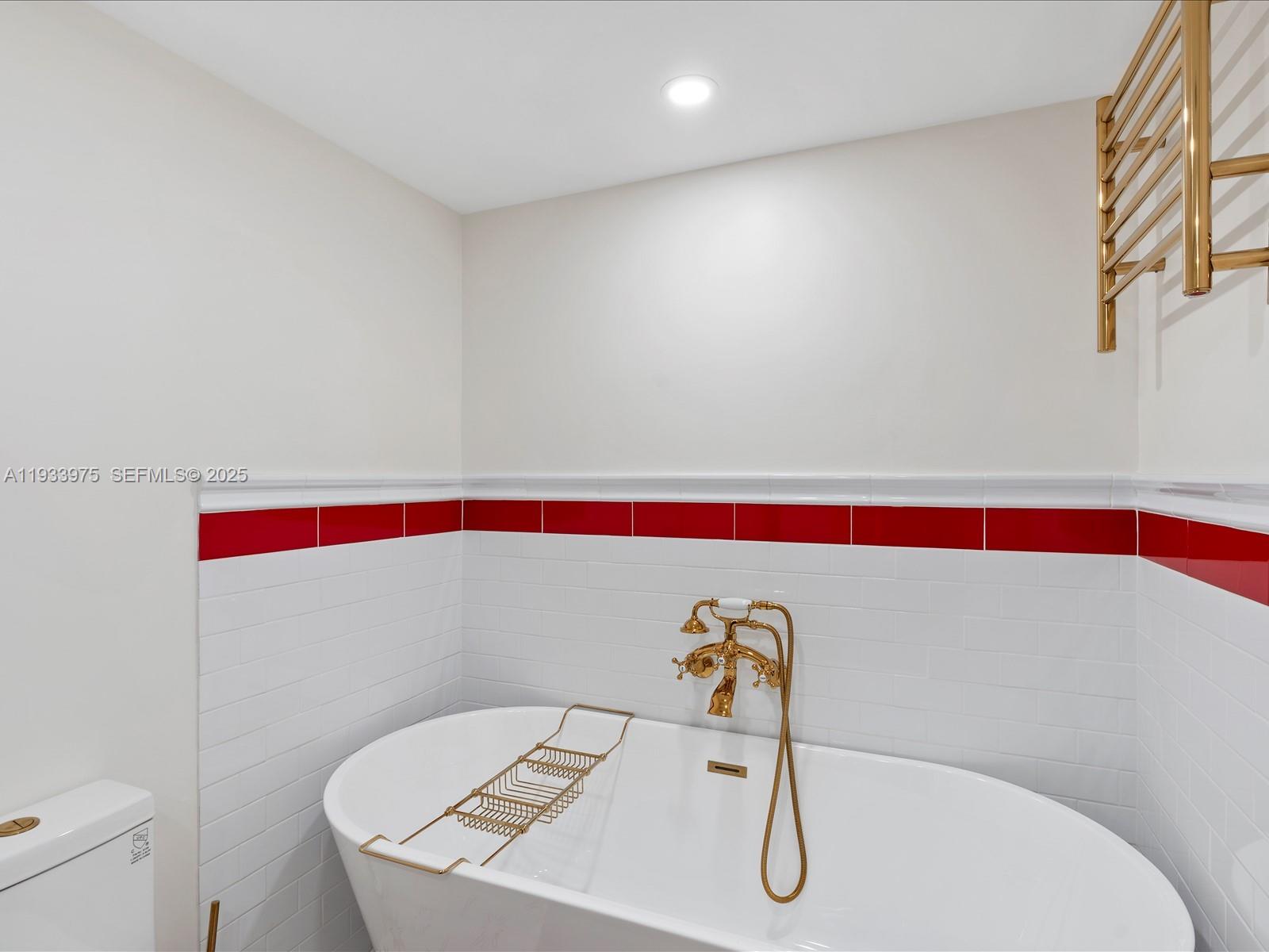 8877 Collins Avenue, Unit 704 Surfside, FL 33154 - Photo 16 of 39 a bathroom with a sink and mirror