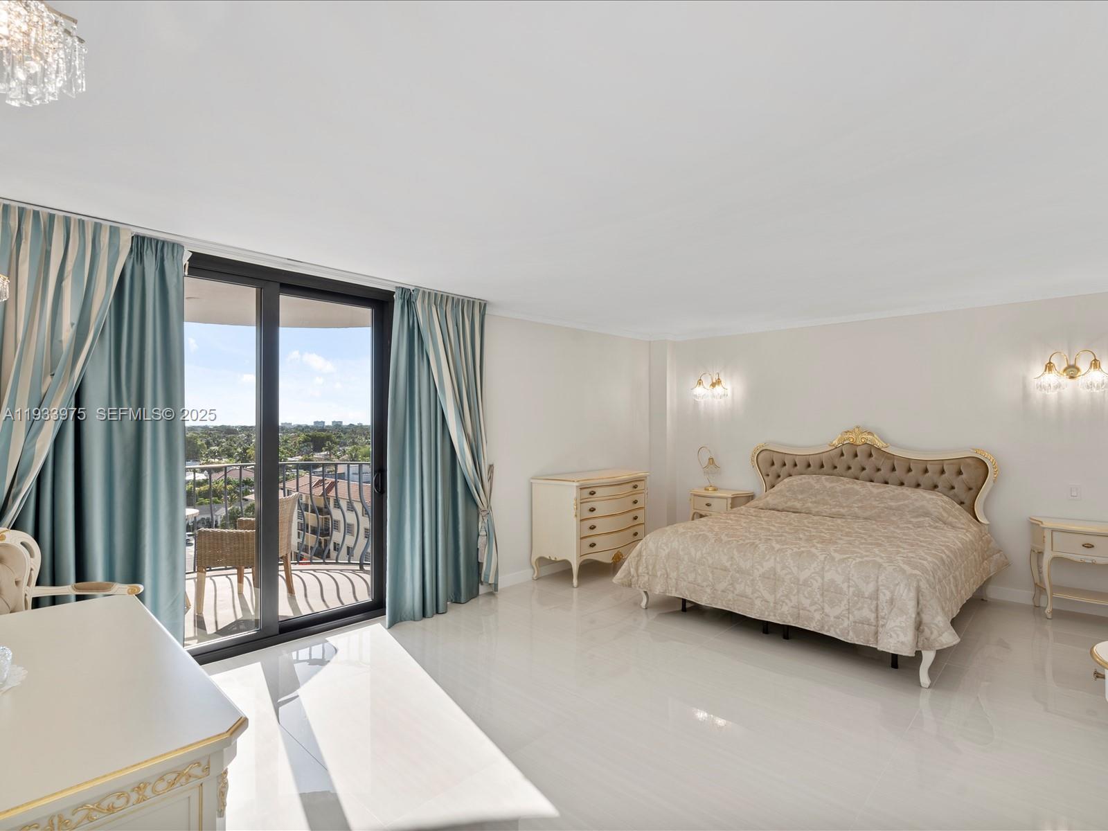 8877 Collins Avenue, Unit 704 Surfside, FL 33154 - Photo 20 of 39 a bedroom with a bed and large window