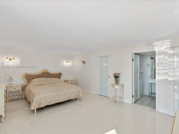 a spacious bedroom with a bed and walk in closet