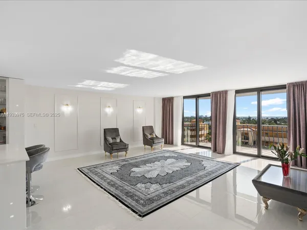a large kitchen with kitchen island a sink table and chairs