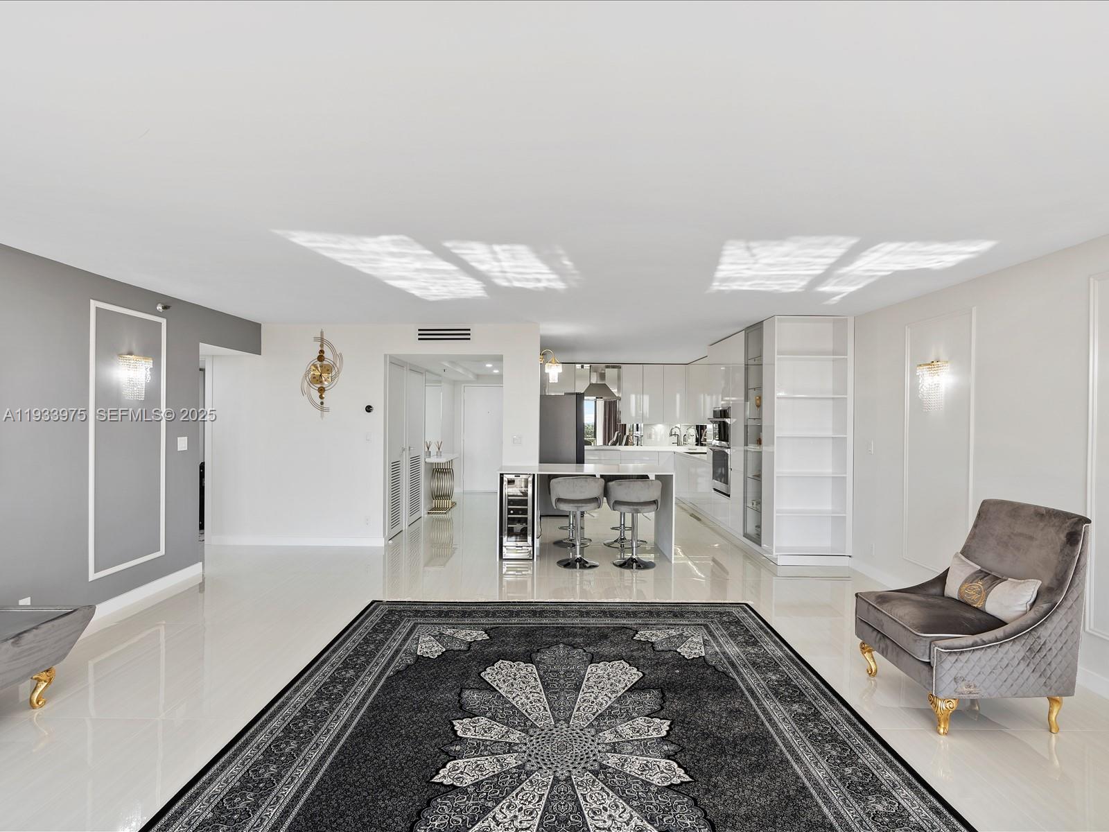 8877 Collins Avenue, Unit 704 Surfside, FL 33154 - Photo 9 of 39 a living room with furniture and a rug