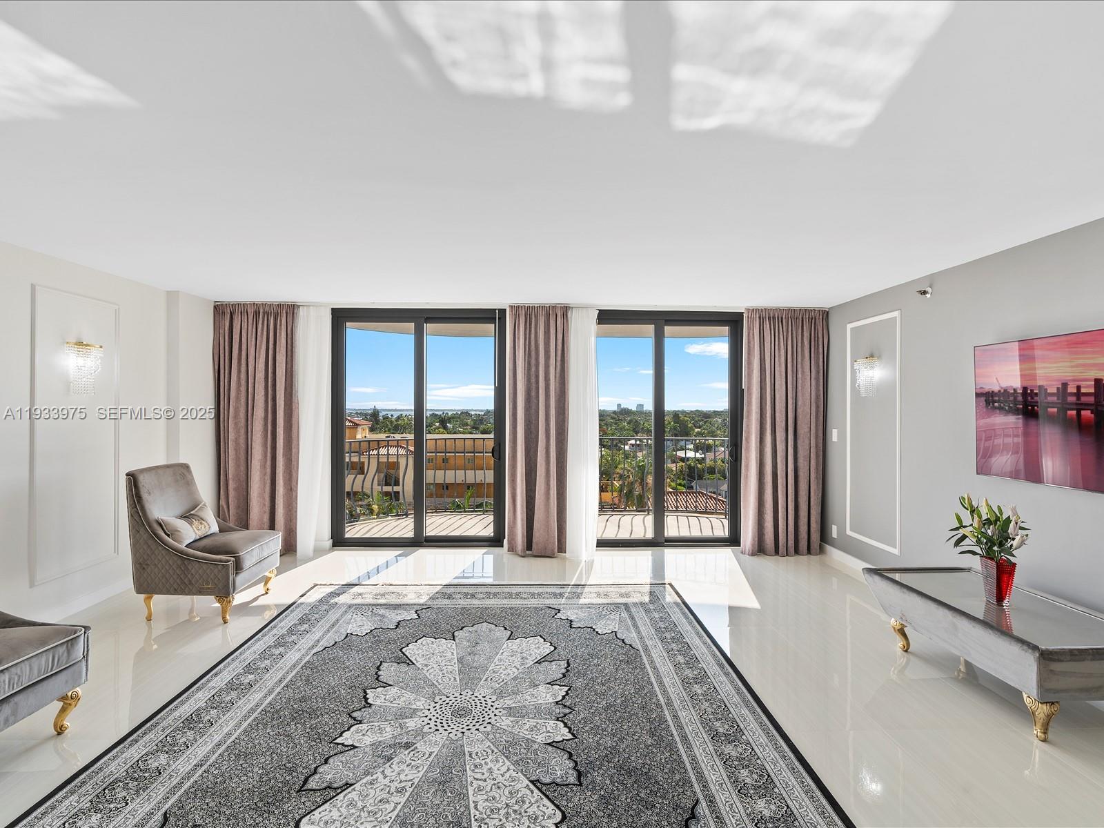 8877 Collins Avenue, Unit 704 Surfside, FL 33154 - Photo 10 of 39 a spacious bedroom with a large bed and a large window