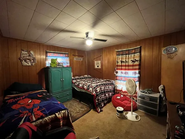 a bedroom with a bed and a gym equipment