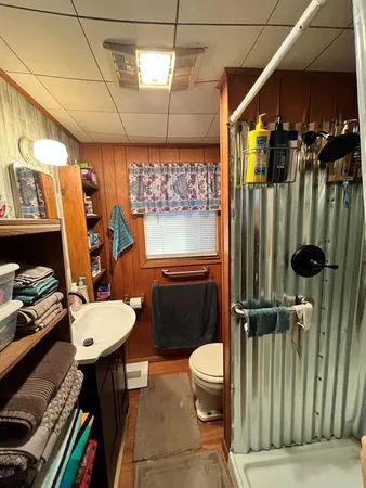 a bathroom with a sink toilet and shower