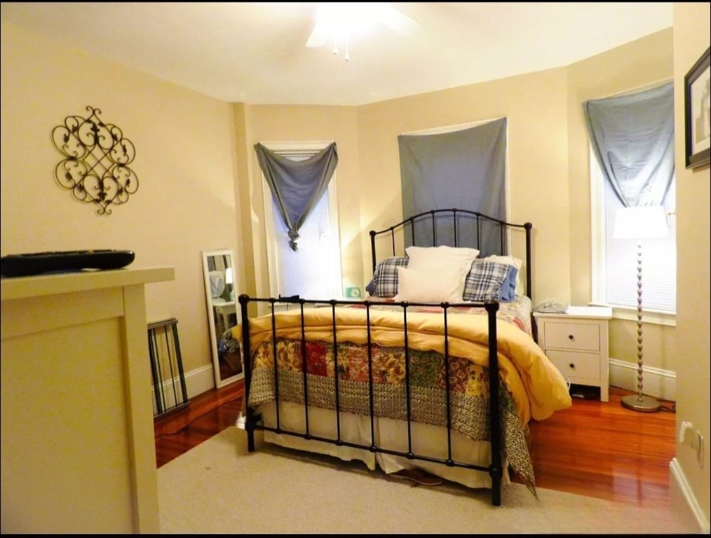 a view of a bedroom with furniture and window