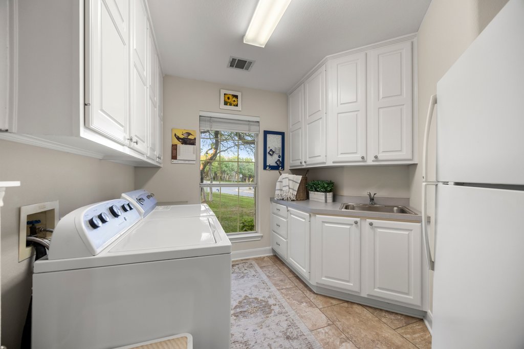 211 River Down Road Georgetown, TX 78628 - Photo 26 of 39 The spacious laundry room offers plenty of room for storage, folding space, and functionality.