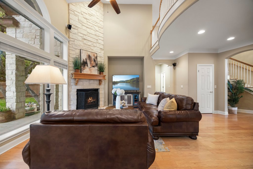 211 River Down Road Georgetown, TX 78628 - Photo 8 of 39 The fireplace anchors the room while the tall ceilings create an airy and inviting atmosphere.