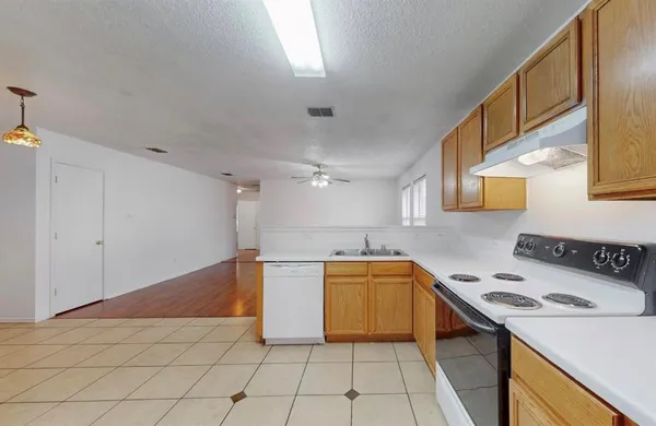 a kitchen that has a sink and a stove
