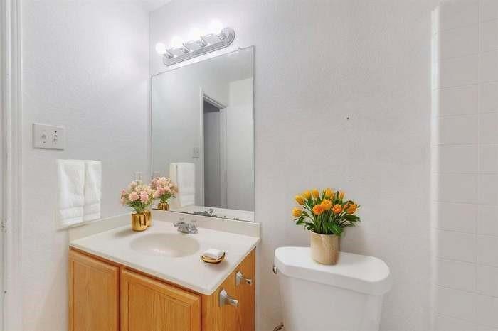 7515 Rice Lane Dallas, TX 75241 - Photo 8 of 15 Bathroom featuring vanity and toilet
