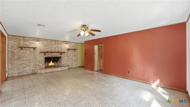 a view of an empty room with a fireplace
