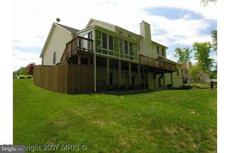 7816 Pohick Road Springfield, VA 22153 - Photo 13 of 30 a view of a big house with a big yard and large trees