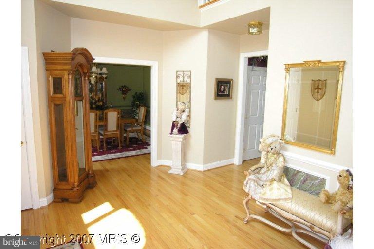 7816 Pohick Road Springfield, VA 22153 - Photo 16 of 30 a living room with a couch and a dining table next to a window