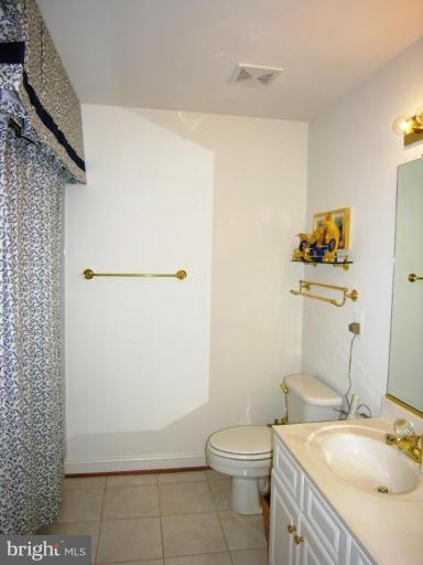 7816 Pohick Road Springfield, VA 22153 - Photo 22 of 30 a bathroom with a sink a toilet and shower
