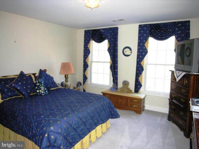 7816 Pohick Road Springfield, VA 22153 - Photo 23 of 30 a bed room with a bed and a window