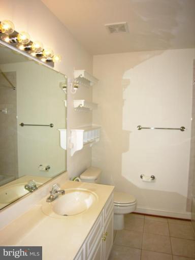 7816 Pohick Road Springfield, VA 22153 - Photo 24 of 30 a bathroom with a sink toilet and shower