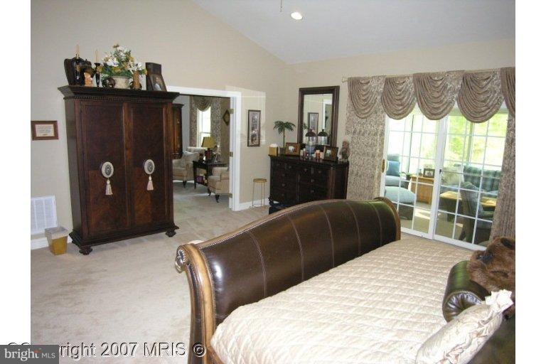 7816 Pohick Road Springfield, VA 22153 - Photo 4 of 30 a bedroom with a bed and a large mirror