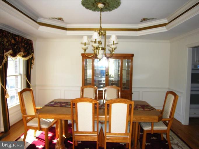 7816 Pohick Road Springfield, VA 22153 - Photo 7 of 30 a view of a dining room with furniture and chandelier