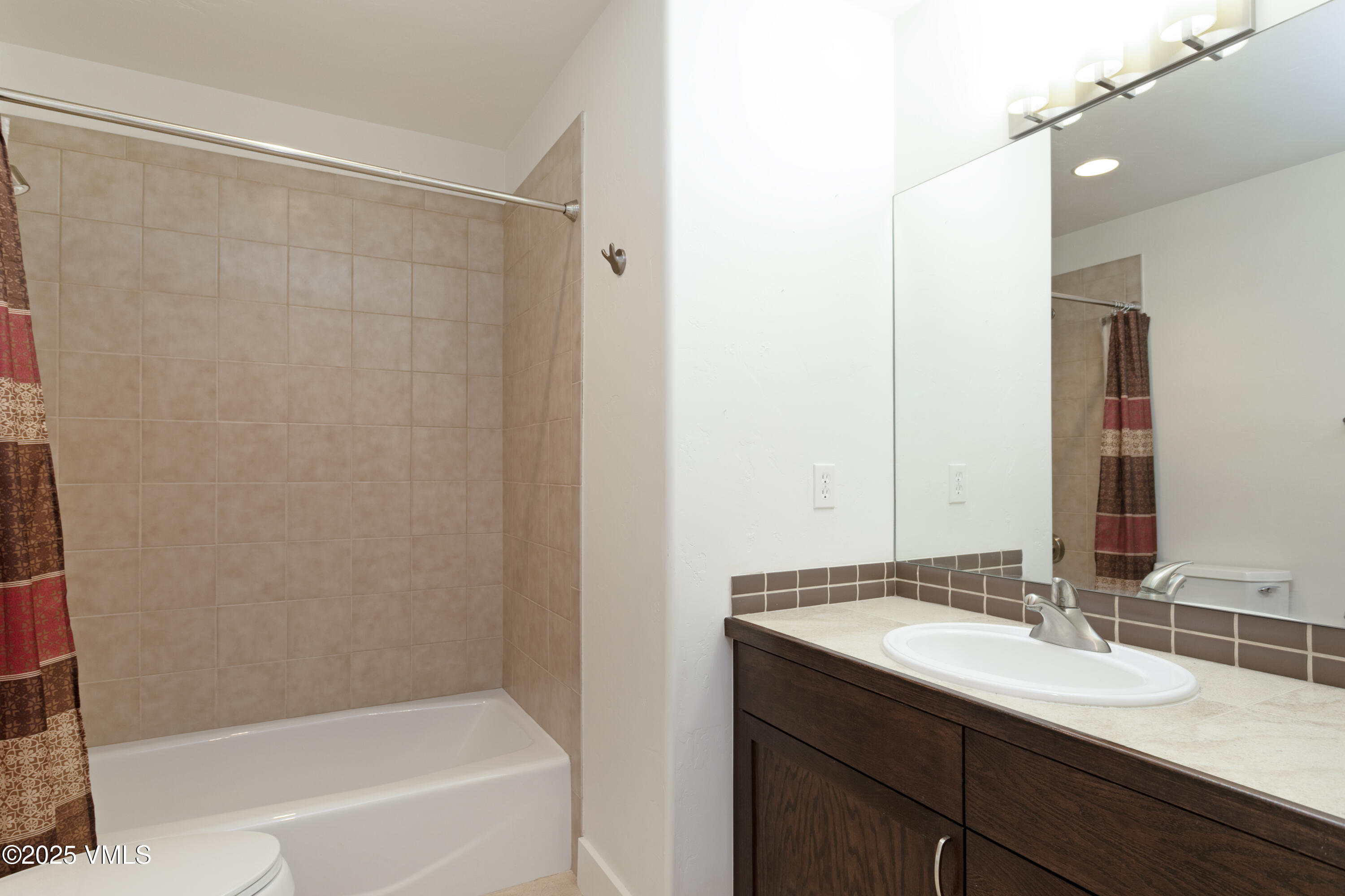 80 Freestone Road, Unit B201 Eagle, CO 81631 - Photo 14 of 24 a bathroom with a granite countertop sink and a bathtub