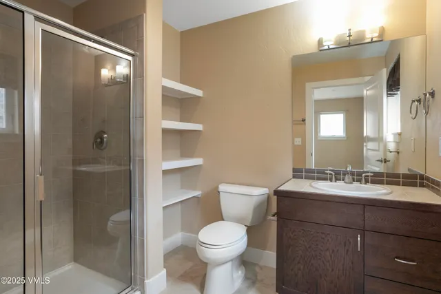 a bathroom with a toilet sink shower and mirror