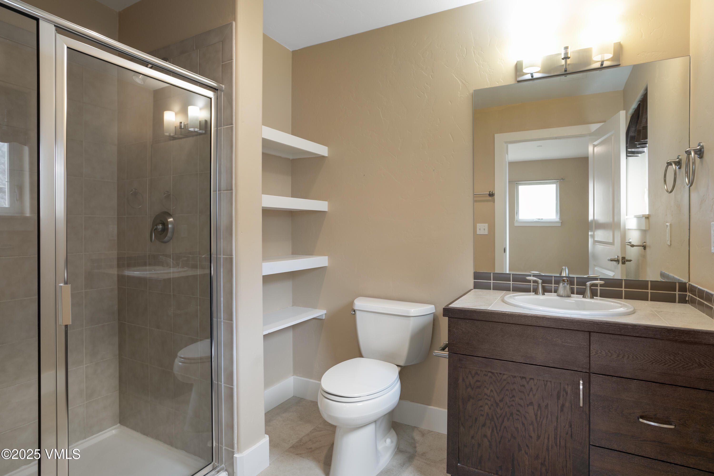 80 Freestone Road, Unit B201 Eagle, CO 81631 - Photo 19 of 24 a bathroom with a toilet sink shower and mirror