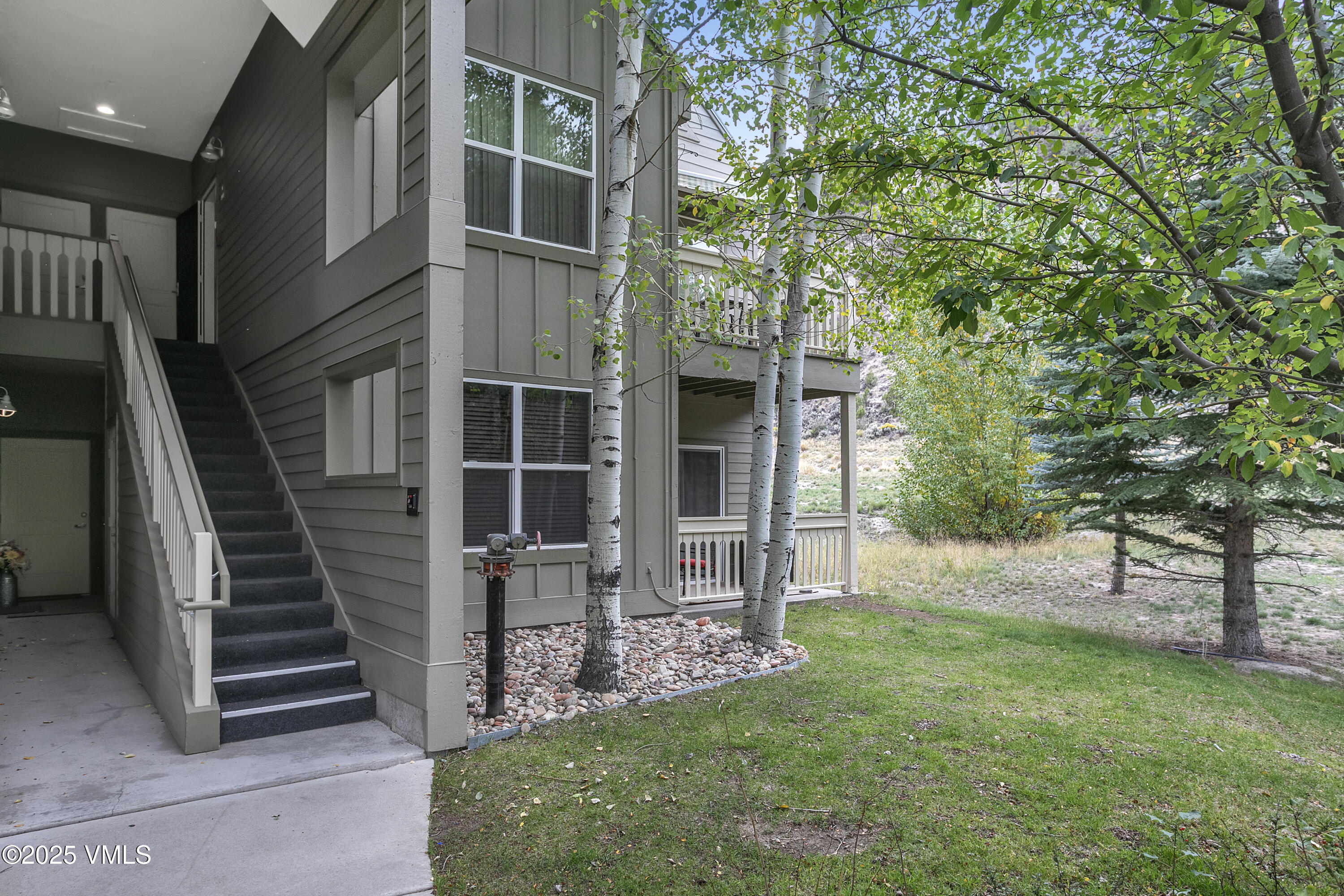 80 Freestone Road, Unit B201 Eagle, CO 81631 - Photo 3 of 24 front view of a house with a yard
