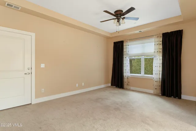 a view of a livingroom with a ceiling fan and window