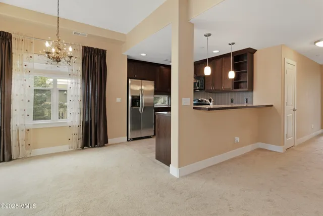 a view of a kitchen with a refrigerator a microwave and a sink
