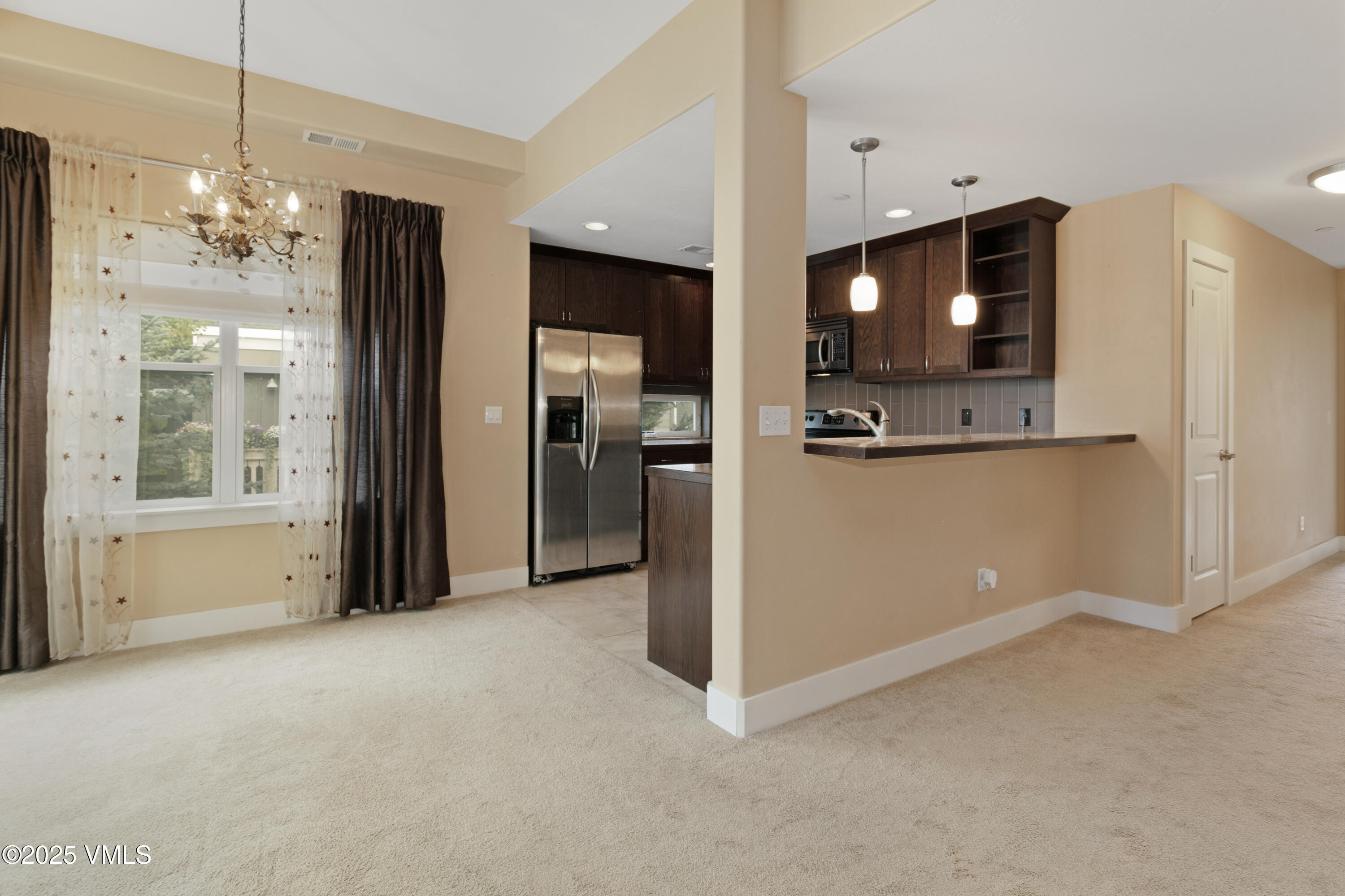 80 Freestone Road, Unit B201 Eagle, CO 81631 - Photo 7 of 24 a view of a kitchen with a refrigerator a microwave and a sink