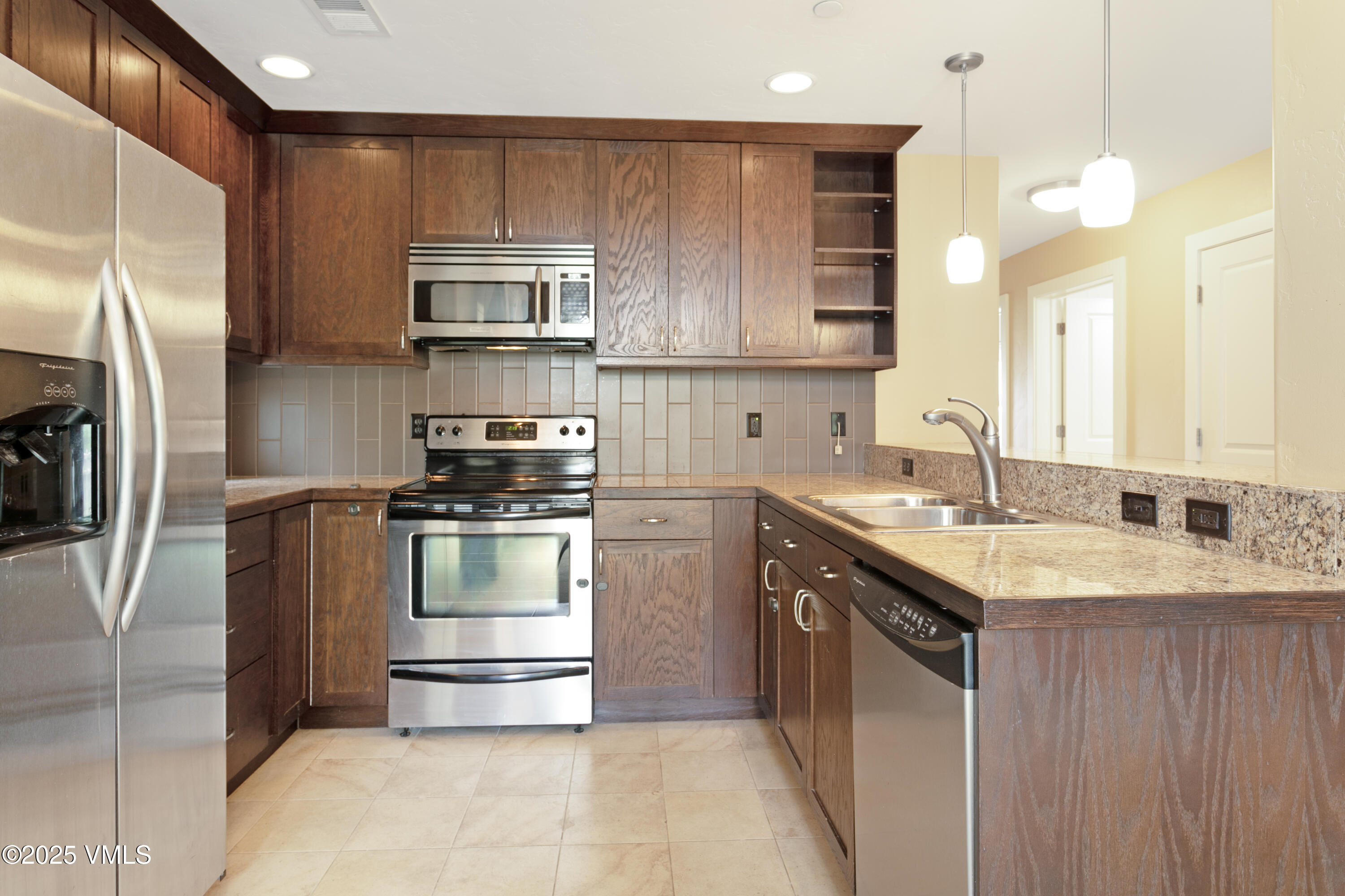 80 Freestone Road, Unit B201 Eagle, CO 81631 - Photo 8 of 24 a kitchen with a sink stove and refrigerator