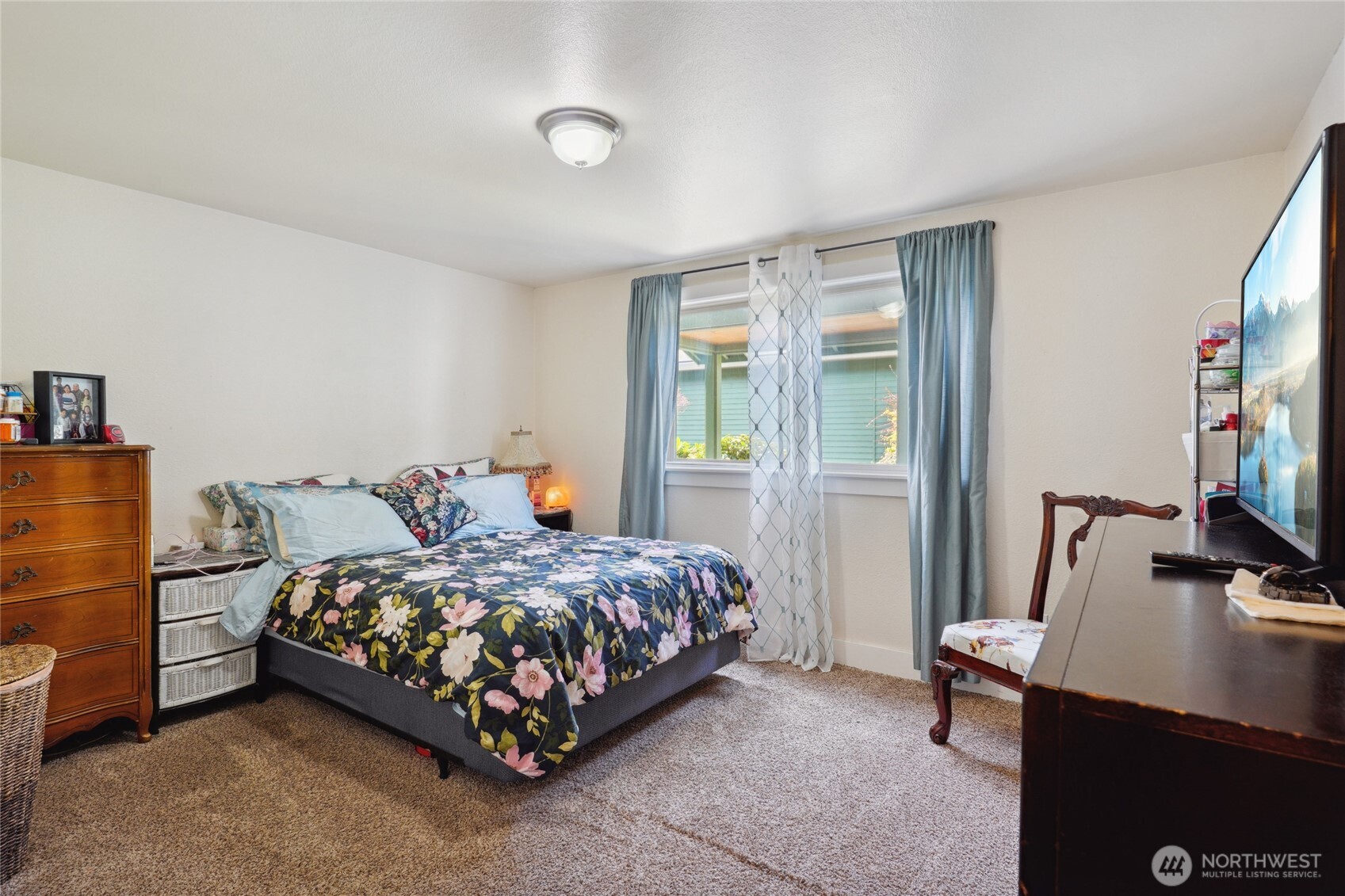 1450 Alameda Avenue, Unit 1 Fircrest, WA 98466 - Photo 12 of 19 a bedroom with a bed and a flat screen tv