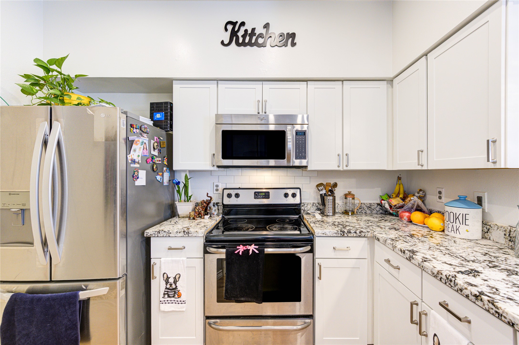 3800 Tanglewilde Street, Unit 803 Houston, TX 77063 - Photo 12 of 36 a kitchen with stainless steel appliances a stove a refrigerator a sink a stove and white cabinets