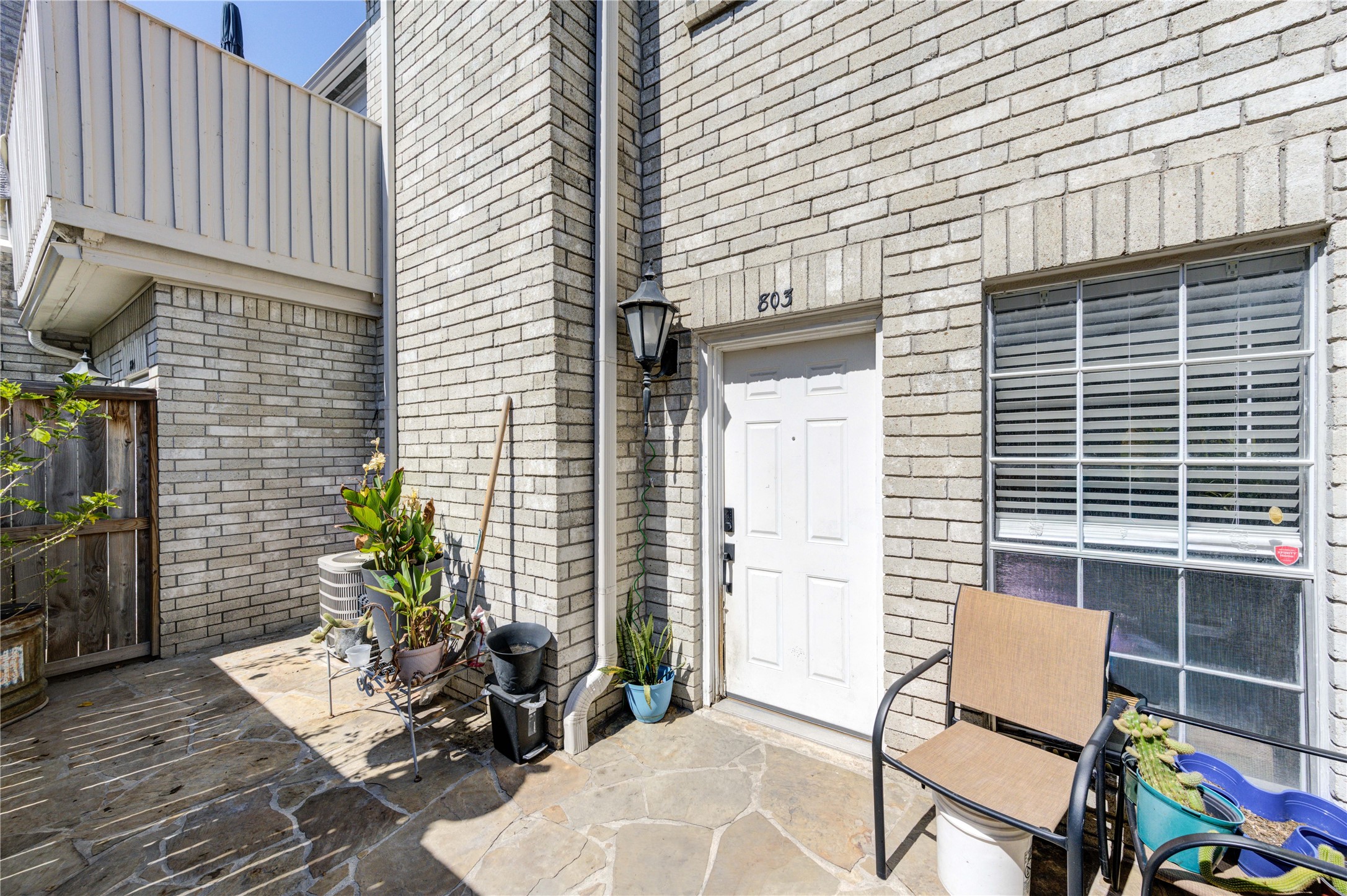 3800 Tanglewilde Street, Unit 803 Houston, TX 77063 - Photo 25 of 36 a patio with table and chairs and potted plants