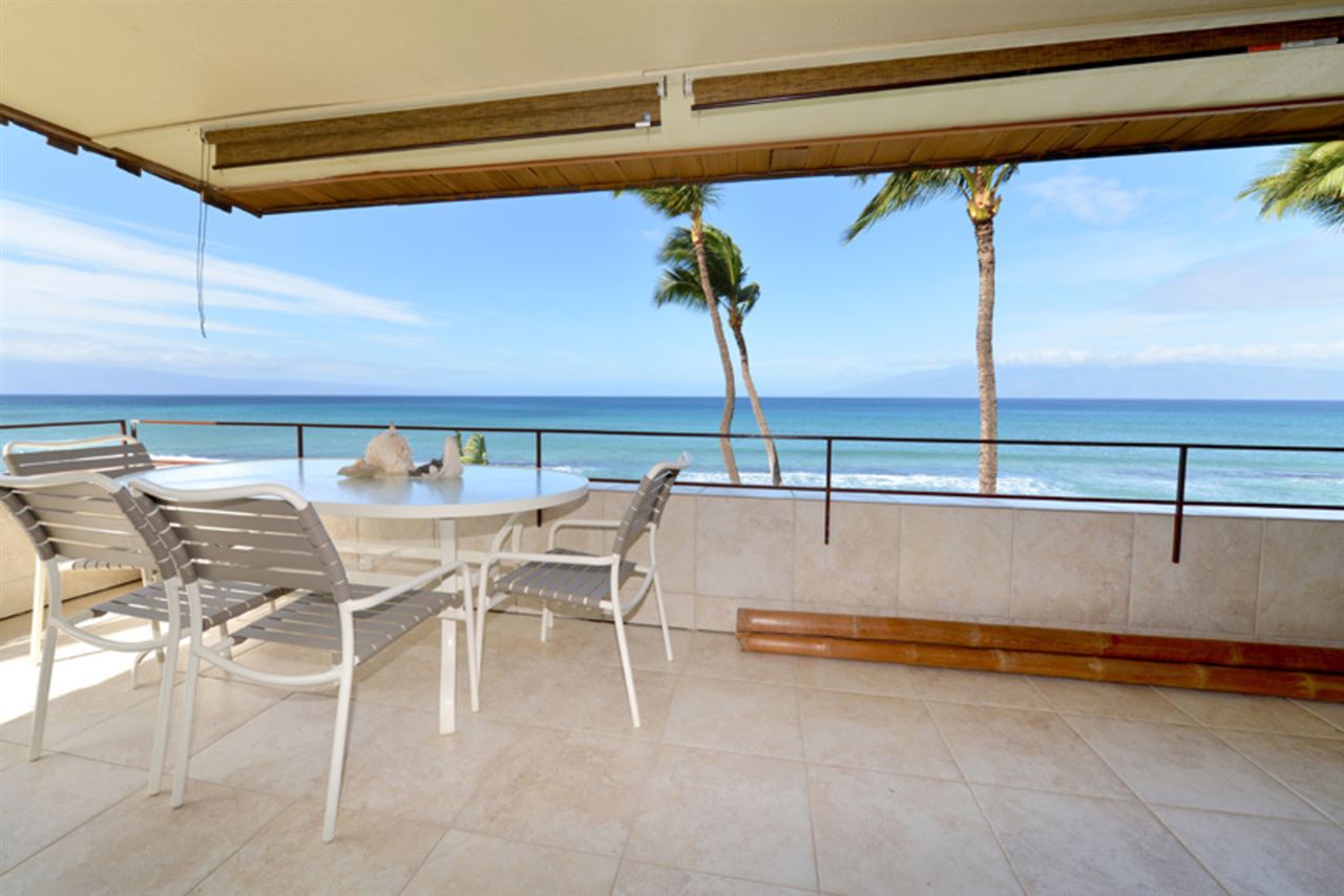 3741 Lower Honoapiilani Road, Unit 301 Lahaina, HI 96761 - Photo 1 of 18 a view of outdoor kitchen with a table and chairs