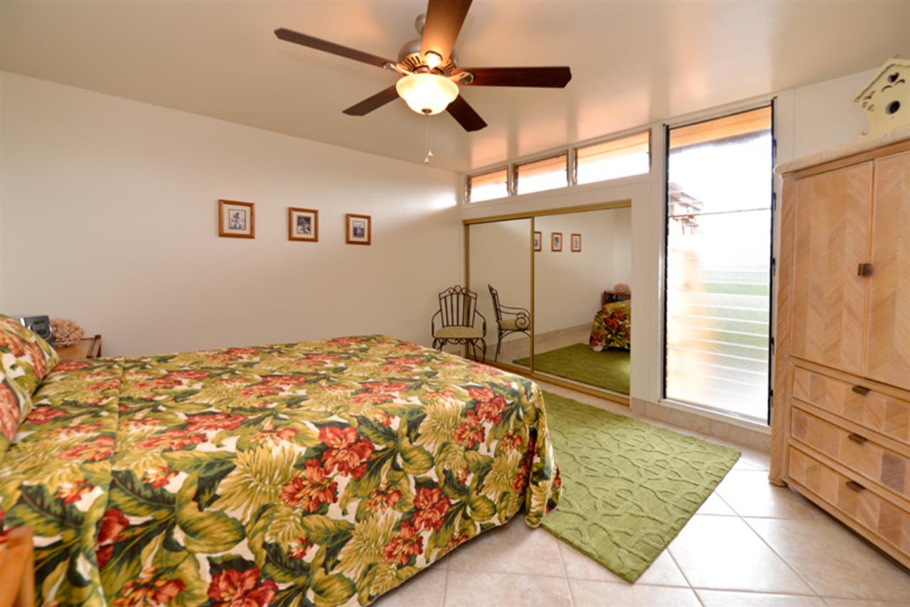 3741 Lower Honoapiilani Road, Unit 301 Lahaina, HI 96761 - Photo 11 of 18 a bedroom with a bed and a chandelier