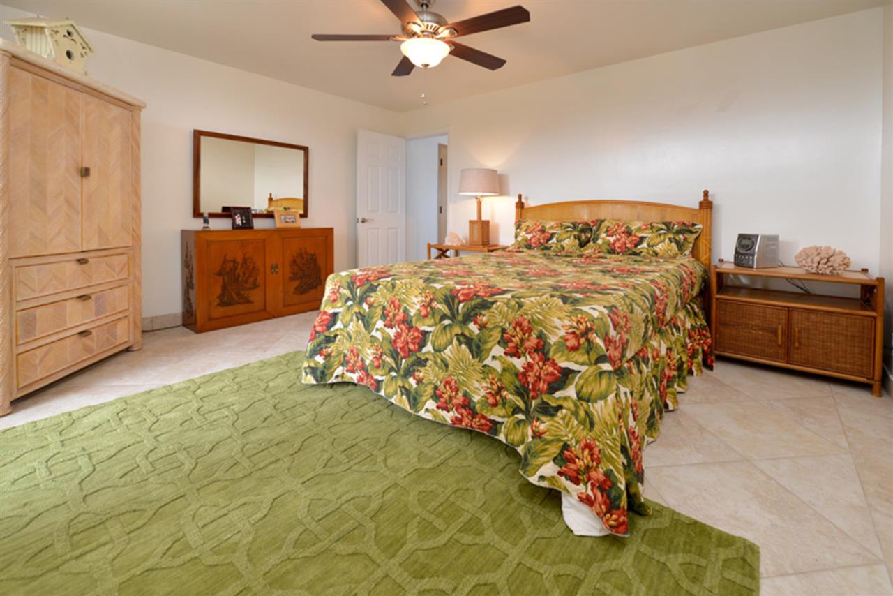 3741 Lower Honoapiilani Road, Unit 301 Lahaina, HI 96761 - Photo 12 of 18 a bedroom with a bed and dresser