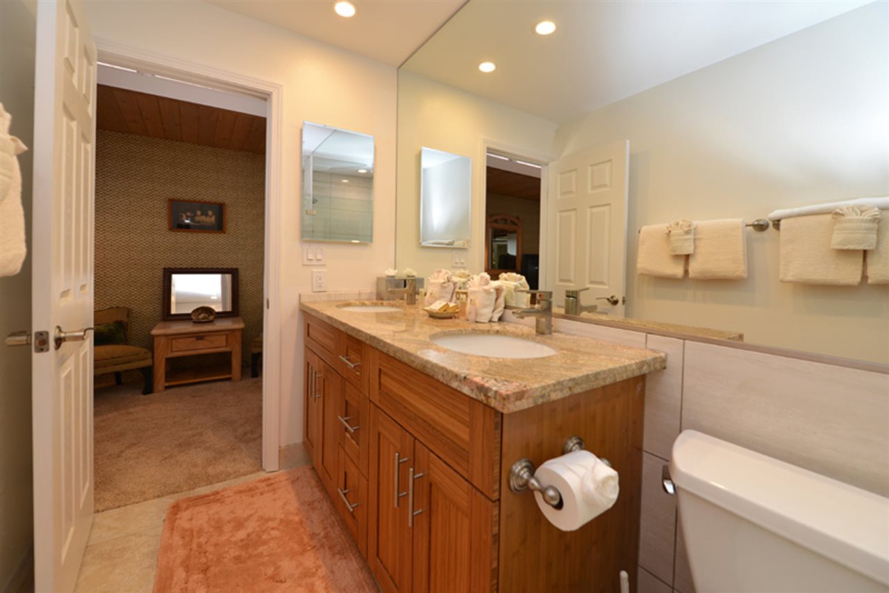 3741 Lower Honoapiilani Road, Unit 301 Lahaina, HI 96761 - Photo 13 of 18 a bathroom with a granite countertop sink a toilet and a mirror