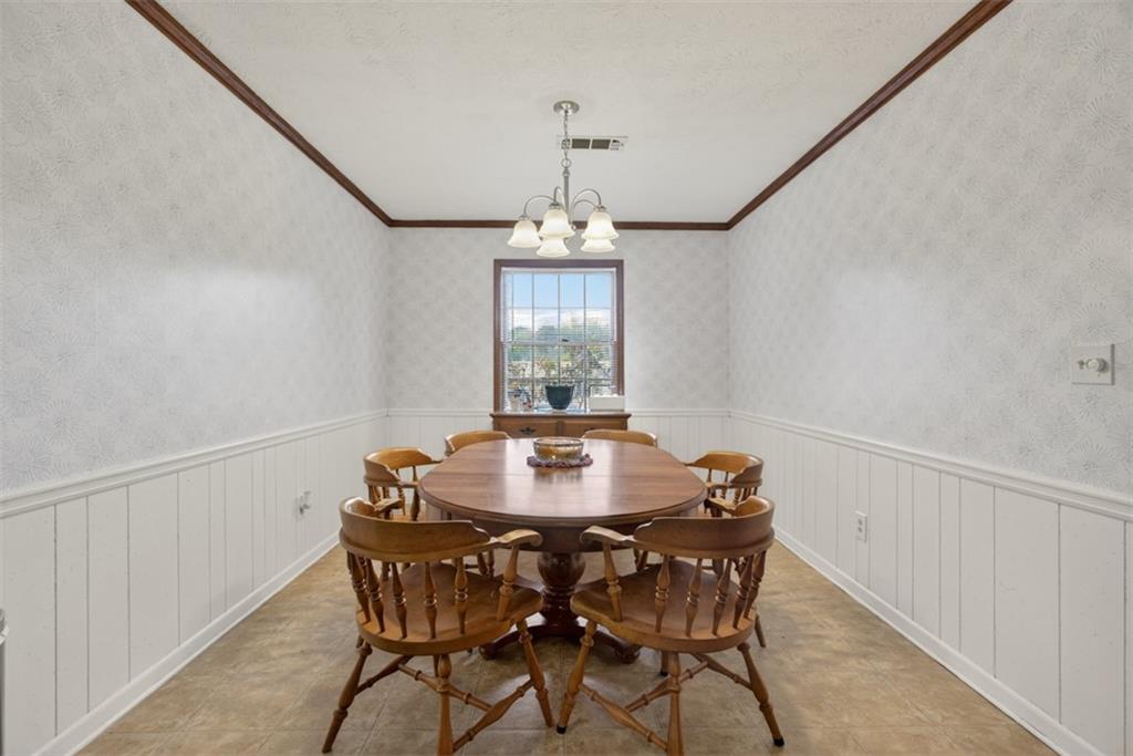 1177 Charlie Lane Southwest Lilburn, GA 30047 - Photo 16 of 49 a dining room with furniture and window
