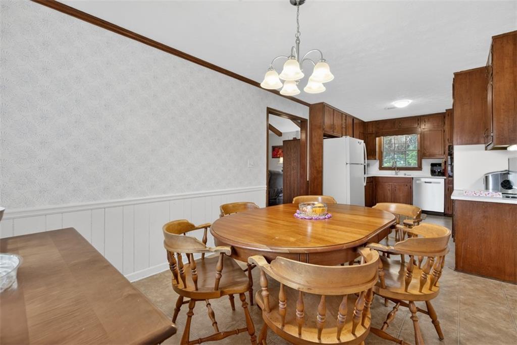 1177 Charlie Lane Southwest Lilburn, GA 30047 - Photo 17 of 49 a view of a dining room with furniture and chandelier