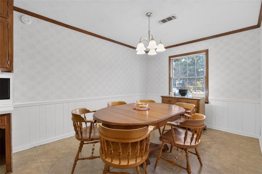 1177 Charlie Lane Southwest Lilburn, GA 30047 - Photo 18 of 49 a view of a dining room with furniture and chandelier