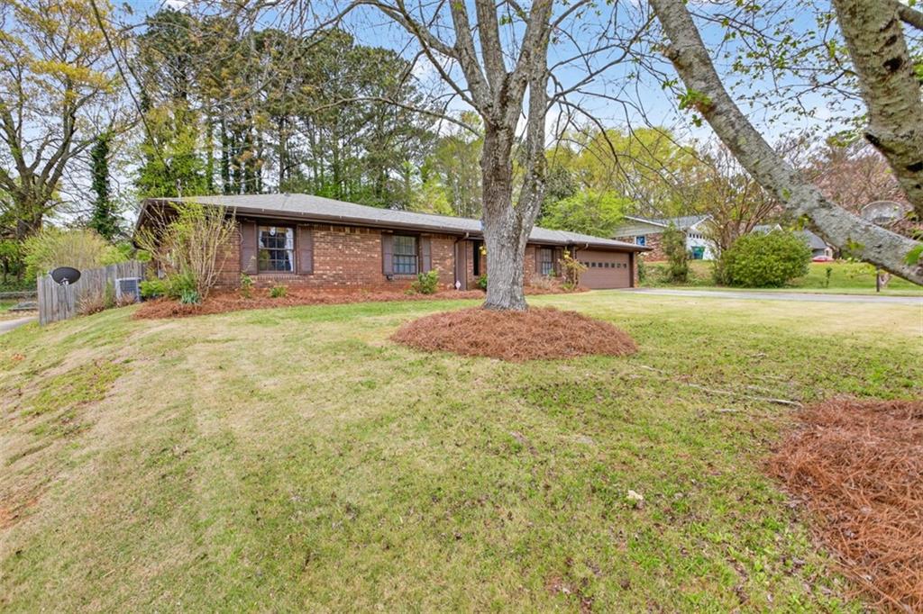 1177 Charlie Lane Southwest Lilburn, GA 30047 - Photo 2 of 49 a front view of house with yard and trees